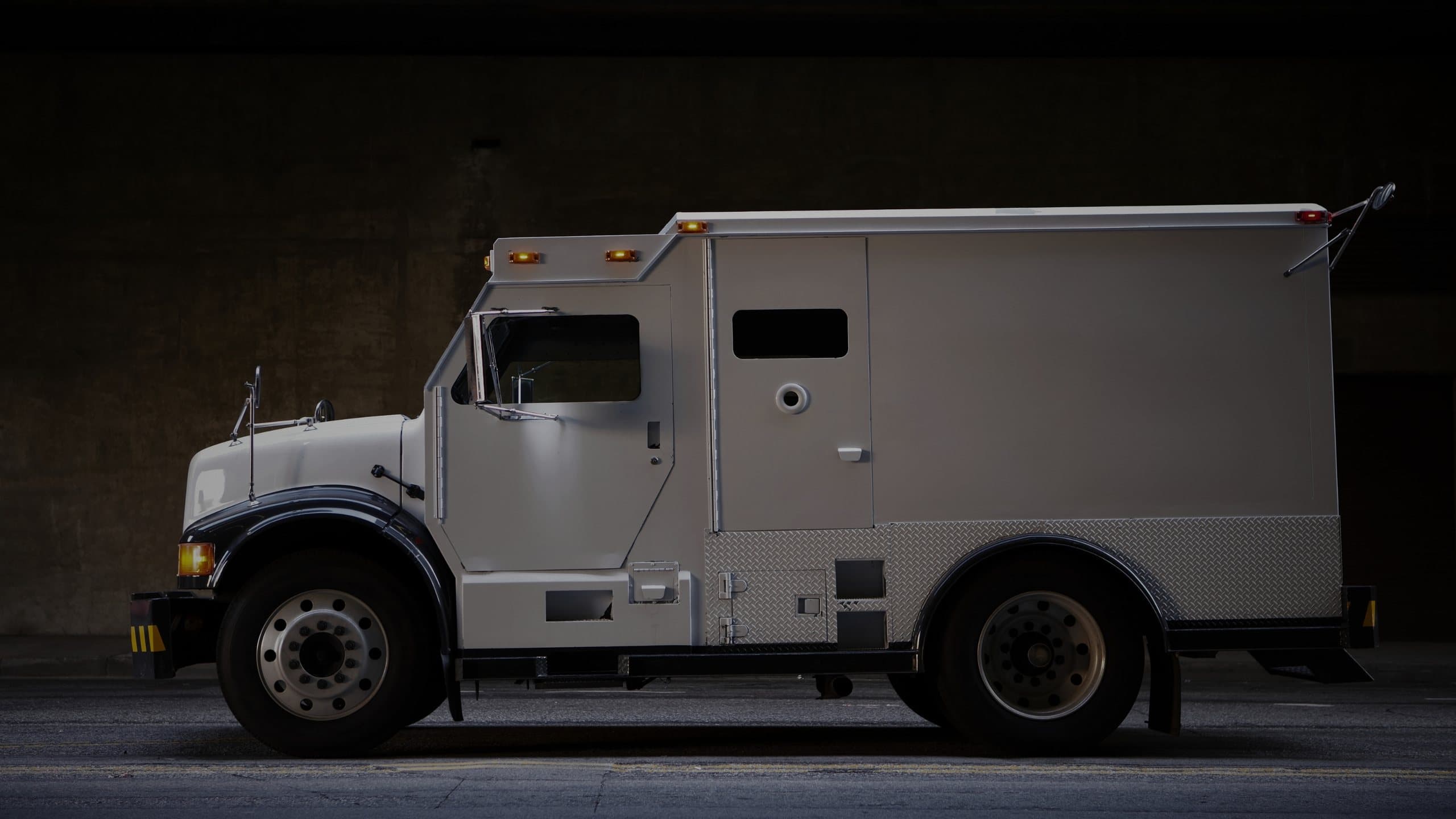 Armoured collection vehicle at dusk
